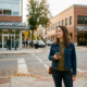 Woman standing outside a healthcare clinic while deciding between primary care and urgent care services.