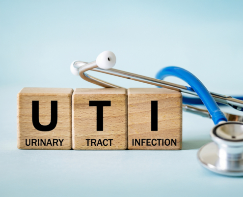 three wooden blocks with the letters spelling UTI.