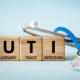 three wooden blocks with the letters spelling UTI.