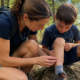 mother and son stopped from hiking. mother examining a tick bit on son's leg