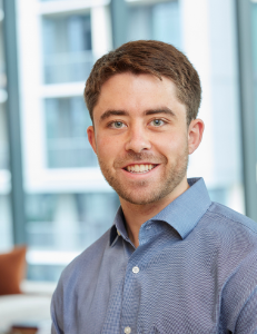 stephen hutchinson Professional headshot of a smiling person in a blue button-down shirt.